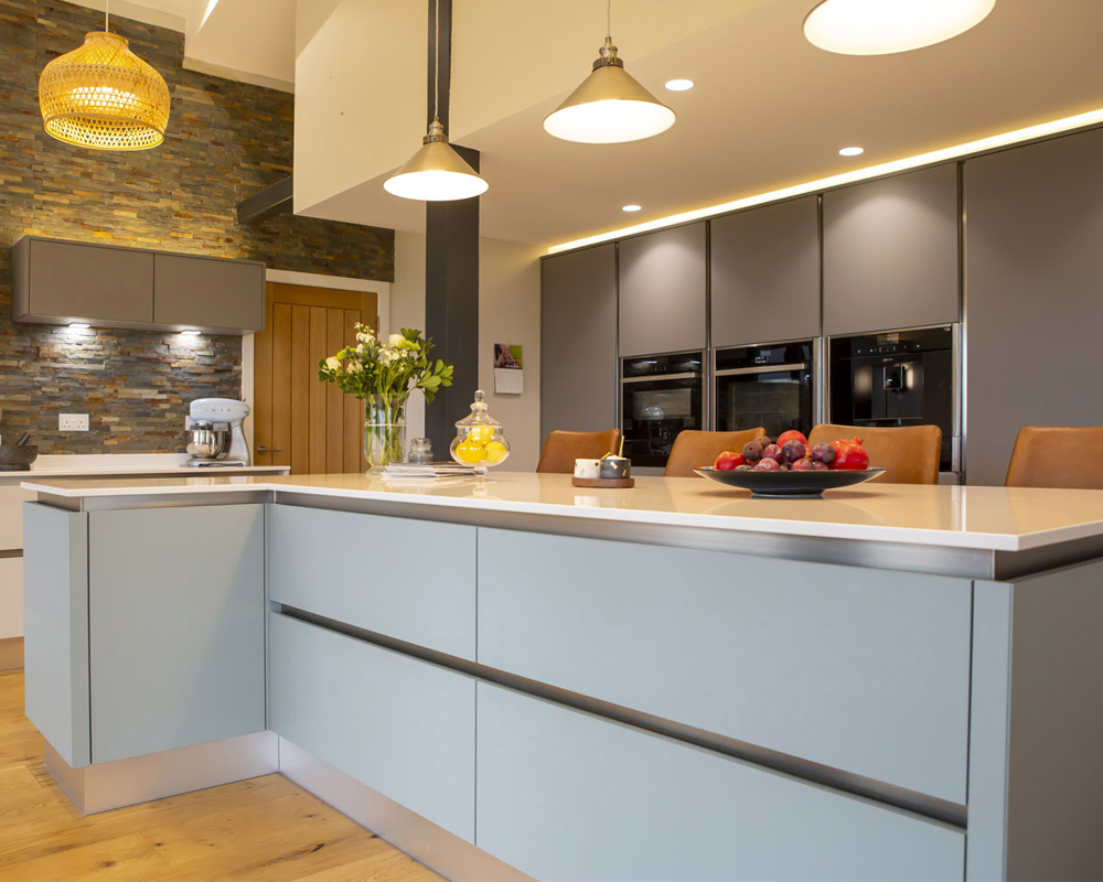 Large kitchen island with clutter free work tops.