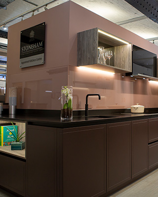 A Stoneham Kitchen handleless kitchen display in Gardiner Haskins Interiors